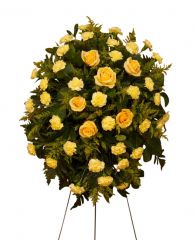 Sunlight Spray of yellow funeral flowers on an easel